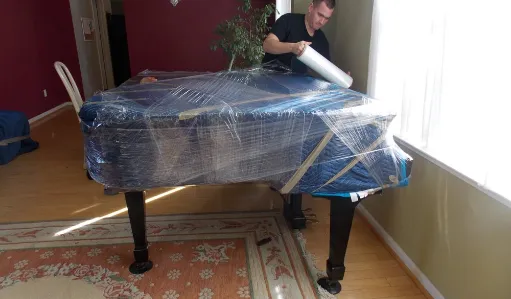 680 movers wrapping piano
